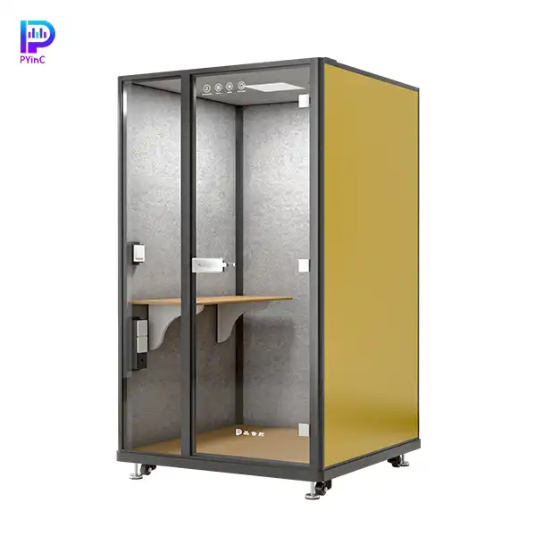 PYinC single-person soundproof office pod in black and yellow, with a desk, front glass panel, and right-opening door.